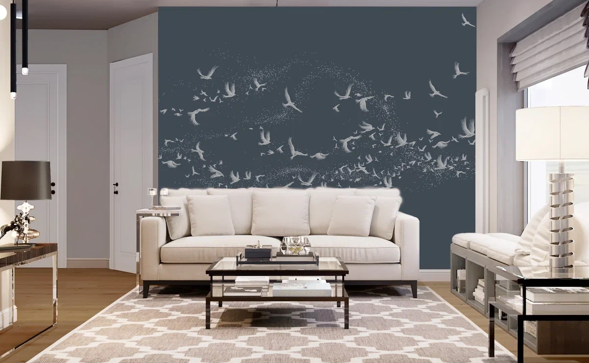 Одна из главных особенностей фешенебельной планировки – объединение 3 главных зон: кухни, столовой и гостиной. Данный дизайн-проект – не исключение. Мы стремились гармонично соединить все зоны воедино. Основными акцентными материалами были выбраны дерева, камень и металл, а цветами – белый, серебряный, серый и золотое дерево.<br><br>

Дизайн-проект этого дома выделяется некоторыми редкими элементами. Например, в каждой спальне есть свой санузел и своя гардеробная комната, что очень удобно. Кухня-столовая – большая зона, где мы разместили не только кухонный гарнитур, но и сделали остров. Г-образная форма кухонного гарнитура позволяет на минимальной площади разместить максимум функционала. А на острове можно не только готовить, но и разместиться на комфортных барных стульях. Это очень удобно: во время готовки собеседник может присесть с бокалом вина и развлекать хозяйку разговорами. Удобство и комфорт – главная задача в создании интерьера. <br><br>

К отдыху располагает и планировка гостиной: окна в пол, большой ТВ-экран, современная стереосистема, комфортные диваны, приятные глазу оттенки в отделке стен и пола. Изюминкой этого помещения стал объёмный круглый пуф-столик и камин позади дивана, облицованный камнем. <br><br>

Поскольку глава семьи много работает по вечерам и не желает мешать домочадцам, была спроектирована и комната хозяина (кабинет + спальня). Это помещение также многофункционально, поскольку во время приезда гостей становится гостевой спальней. Комната оформлена в «брутальных» цветах: темно-серый, коричневый, бордо. Мужской характер помещения мы усилили за счет интересного приема в дизайне. У изголовья кровати разместили декоративные 3d-панели из МДФ, скрытые двери в санузел и гардеробную. <br><br>

Хозяйственные помещения в дизайне интерьера уже не являются чем-то диковинным: топочная, постирочная, комната с душем-лапомойкой, гардеробная. Однако в этом проекте мы дополнили этот «хозяйственный минимум» второй гардеробной комнатой, в которой будут храниться сезонные вещи. <br><br>

Этот проект убедительно демонстрирует: хороший дизайн дома всегда должен отвечать трем требованиям – быть стильным, уютным и функциональным.
